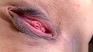 Breathtaking model is showing off her stretched narrow slit in closeup