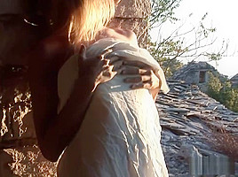 Exposed breasts staring into the sunset