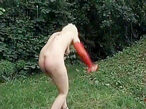 German slut masturbates in the backyard