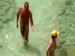 Mature nudist with yellow hat on her head