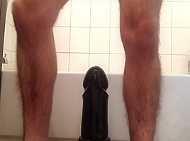Riding giant black dildo